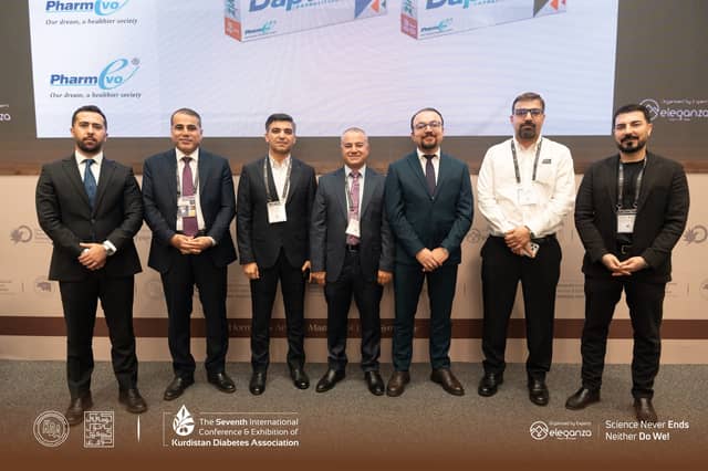 A second frame of Dr. Karzan with fellow faculty members