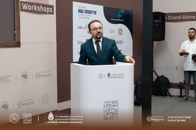 Dr. Karzan speaking at the conference lectern