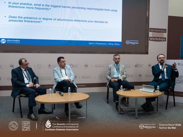 Four panellists seated before a screen of discussion questions